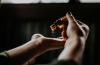 person putting oil in hands