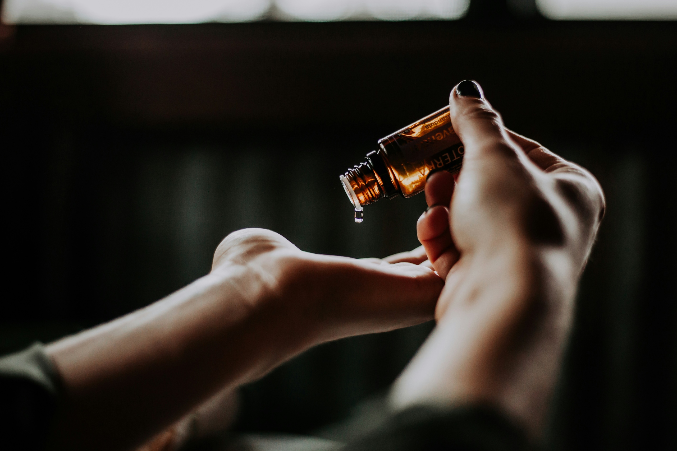 person putting oil in hands